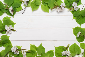 Decorative frame of green leaves and white flowers