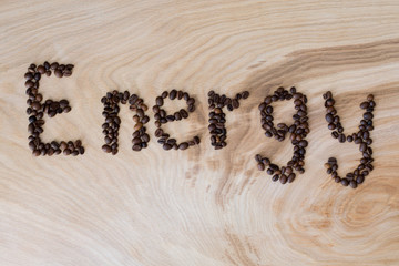 Word energy laid out from coffee grains on a wooden background