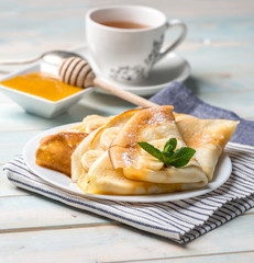 Pancake stack filled with banana slices and honey