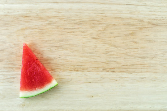 Sliced watermelon on wood background.