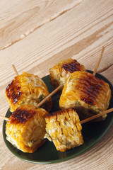 Corn cobs cooked on a grill