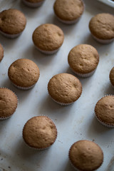 Freshly baked delicious homemade cupcakes on an old baking tray closeup