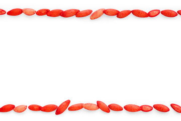 Red cucumber seeds as frame on white background