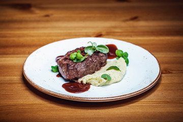 Sliced Gammon Steak with mashed potato on wooden background