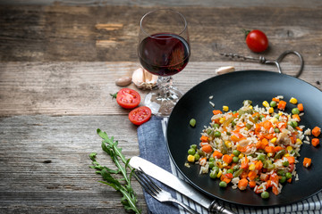 Yummy pilaf with vine and tomatoes on side