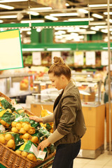 Middle-age woman buying vegetables at the market