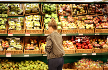 Middle-age woman buying vegetables at the market