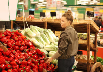 Middle-age woman buying vegetables at the market