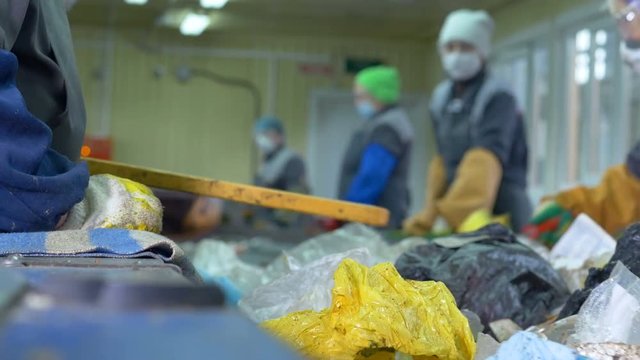 Worker sorting waste. No face. Close up. 4K.