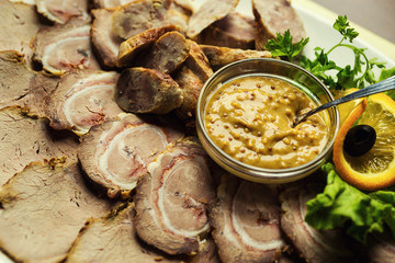 Meat assortment of beef, sausage and ham with greens,meat plate,Sliced boiled ham sausage,Meat with mustard sauce,Cold cuts