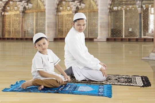 Family praying together in the mosque