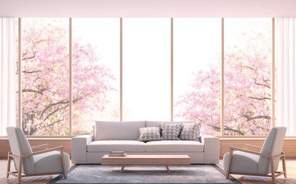 Modern living room decorate room with wood  3d rendering image.There wooden floor and  large window Look out to see the tree with pink flowers.