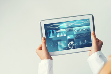 Close of female doctor hands working with tablet pc computer