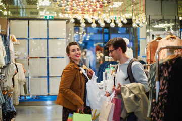 Woman and man in clothing store