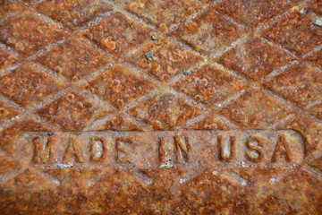 Rusted  Made in USA cast iron cover on sewer drain