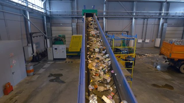 Waste disposal plant's conveyor transporting the garbage.4K.