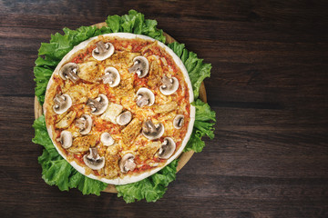 Pizza with mushrooms and meat on salat