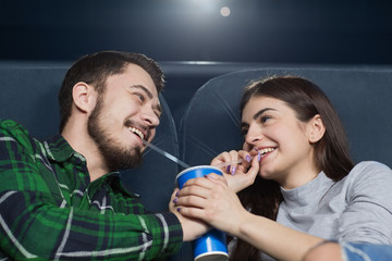 Happy young couple having a date at the cinema