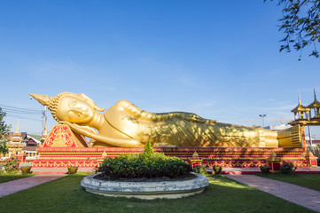 Fototapeta na wymiar Laos Golden Reclining Buddha adjacent to Pha That Luang in Vientiane, Laos