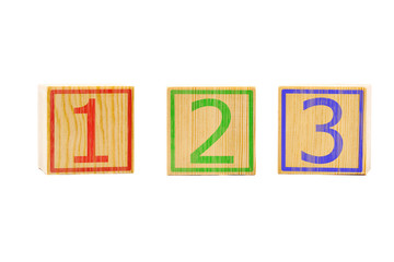 Three brown wooden cubes lined up in a row with numbers one, two and three - education or counting...