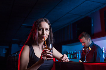 Beautiful girl Enjoys Evening Drinks In Bar. Selective focus.