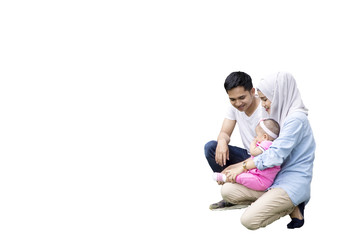 Muslim family sitting in studio