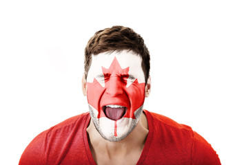 Screaming man with Canada flag on face.