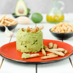 Avocado Hummus with mini grissini, rustic still life