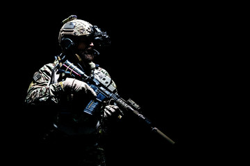 Bearded soldier in Combat Uniforms with weapon, plate carrier and combat helmet are on. Studio...