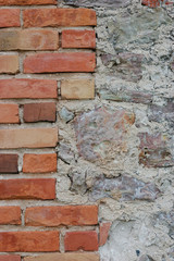 Stone wall background closeup vertical plastered grunge red brick stonewall beige limestone pattern old aged weathered beige lime plaster texture grungy textured vintage rough rustic bricks birckwork