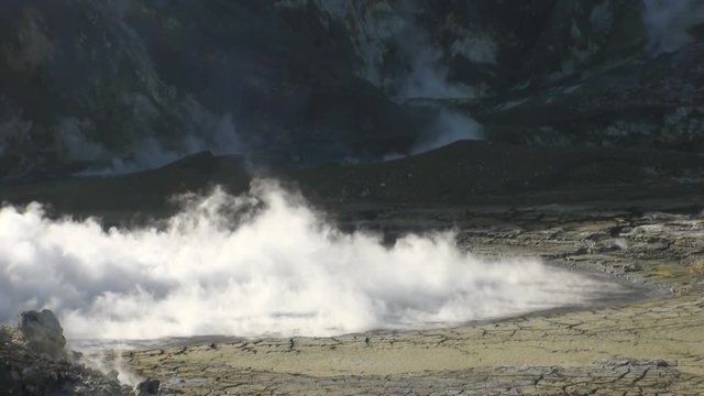 Geysers of a volcano in the mountains on the White Island in New Zealand. Beautiful amazing nature. Travel and tourism in the world of wildlife.