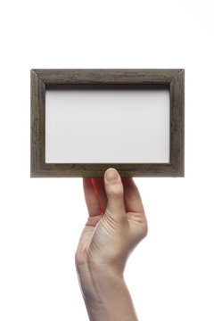 woman hand hold a photo frame isolated white.