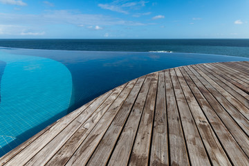Obraz na płótnie Canvas Beautiful infinity pool and wood deck