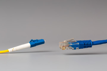 Close-up of optical patch cord lc and copper cable with plug rj45 - obrazy, fototapety, plakaty