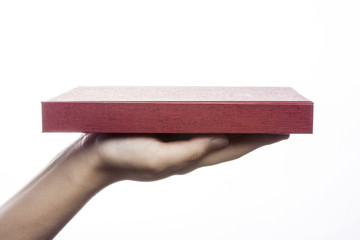 woman hand hold a red book cover isolated white.