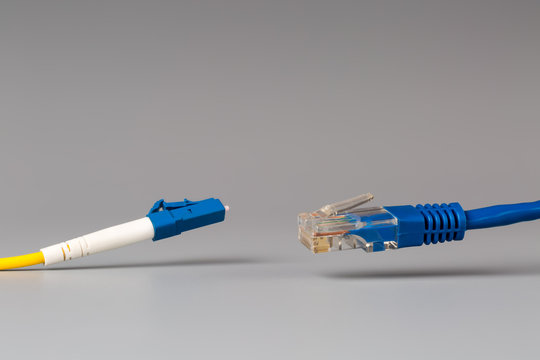 Close-up of optical patch cord lc and copper cable with plug rj45