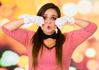 Closeup portrait of female clown mime expressing sadness