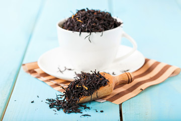 Tea leaves in a cup on a table. Selective focus. Copy space