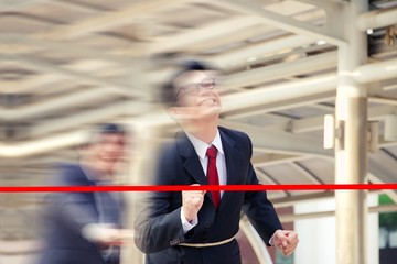 Business man is running to finishing line