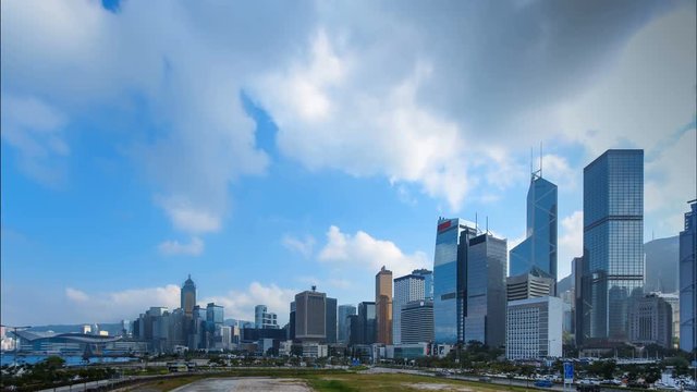 4K Time lapse of office building and business tower in downtown showing clouds moving overhead. Panorama scenery view of Skyscraper in city center with copy space background for text and title design.