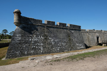 Moat and grass that surrounds the oldest fortress in America, Castillo de San Marcos, in St Augustine, Florida. Corner turret and battlements of historic fortress.