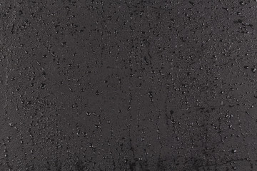 Water drops on dark stone