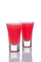 Two strawberry cocktails in shot glass with reflection isolated on white background