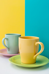 Close-up of two ceramic mugs and saucers for coffee.