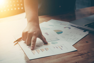 Businessman calculate cost and expenses using laptop for search data result.