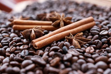 Closeup of star anise, fresh fragrant vanilla pods, cinnamon sticks and coffee grains, seasoning ...