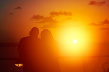 Fototapeta na wymiar Couple watching sunset from cruise ship