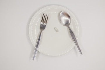 Capsule on white dish