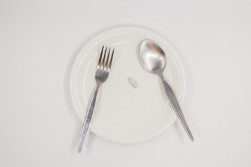 Capsule on white dish