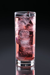 Red drink on a black glossy background